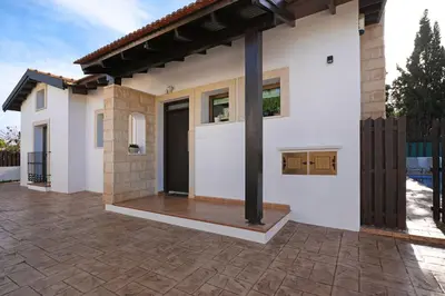 a detached house with a porch and a patio at Villa Anthia - 2bed with Large Pool in Ayia Napa