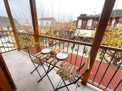 a balcony with a table and chairs on a balcony at Maison Damianou Elegant Loft in Omodos