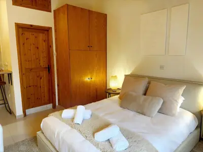 a bedroom with a white bed with towels on it at Maison Damianou Elegant Loft in Omodos