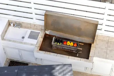 an overhead view of a bathroom with a sink and a basket of fruit at Faros Seaside Villa Larnaca in Pervolia