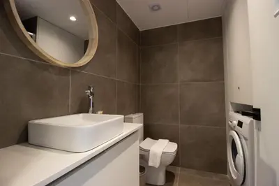 a bathroom with a sink and a toilet and a mirror at Flat in Nicosia's centre in Nicosia