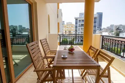 a table and chairs on a balcony with a view at Flat in Nicosia's centre in Nicosia