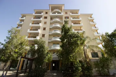 an apartment building with trees in front of it at Flat in Nicosia's centre in Nicosia