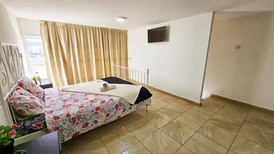 a bedroom with a bed and a window at Duplex Apartment in Larnaka
