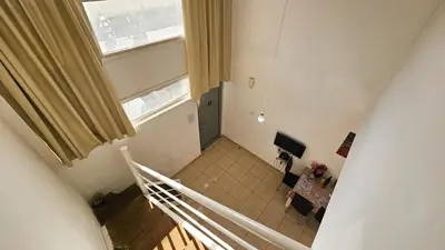 an overhead view of a staircase in a room with a window at Duplex Apartment in Larnaka