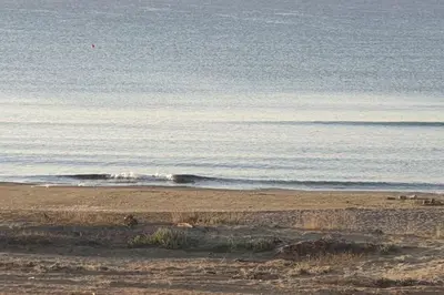 a beach with a body of water and the ocean at Sea Heart Villa Beachfront in Pyla