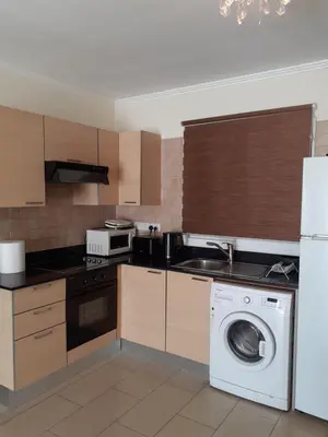 a kitchen with a washer and a washing machine at Luxury Cozy Apartment near NISSI BEACH in Ayia Napa