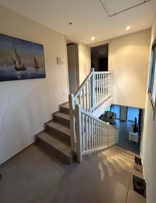 a staircase in a house with a painting on the wall at Beautiful maisonette in Protaras in Protaras