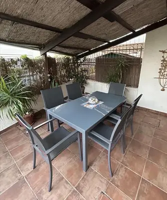 a blue table and chairs on a patio at Beautiful maisonette in Protaras in Protaras