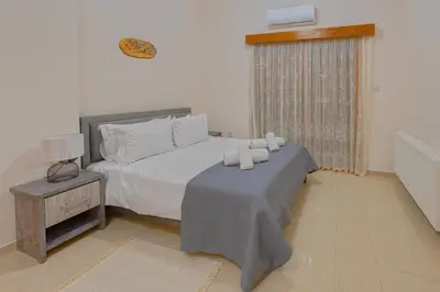 a bedroom with a bed with white pillows on it at Eidyllio ''The Mansion'' in Omodos