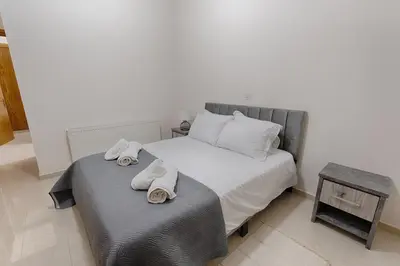 a bedroom with a bed with towels on it at Eidyllio ''The Mansion'' in Omodos
