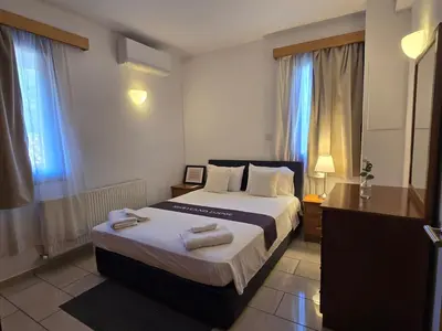 a bedroom with a bed with two towels on it at Maryland Lodge kakopetria in Kakopetria