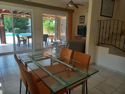 a dining room with a glass table and chairs at Villa Penny in Pissouri
