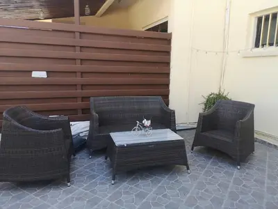 a patio with three chairs and a table with a bicycle on it at Miranda Beach House in Voroklini