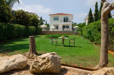 a yard with a table and chairs and a house at Horizon Villa Protaras in Protaras