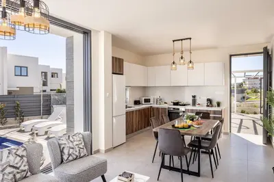 a kitchen and living room with a table and chairs at Protaras Hestia Seaside Villa B6 in Protaras