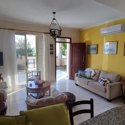 a living room with a couch and a table at Quiet holiday house near the beach in Meneou