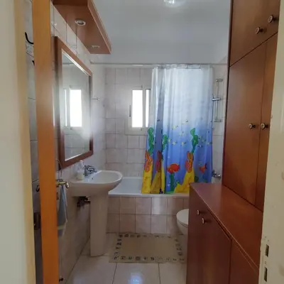 a bathroom with a sink and a shower curtain at Quiet holiday house near the beach in Meneou
