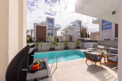 a villa with a swimming pool and a house at Protaras By the Bay Villa 32 in Protaras