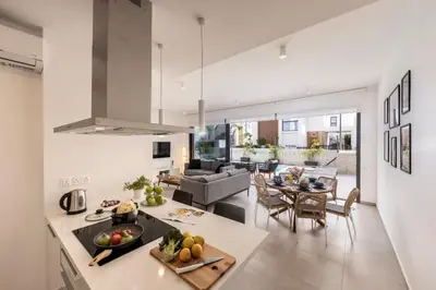 a kitchen and living room with a couch and a table at Protaras By the Bay Villa 32 in Protaras