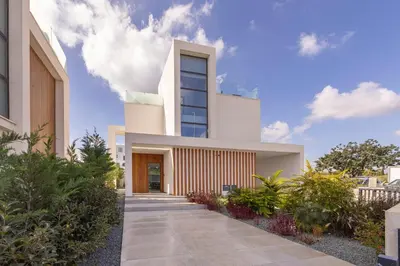a modern house with a walkway in front of it at Protaras By the Bay Villa 33 in Protaras