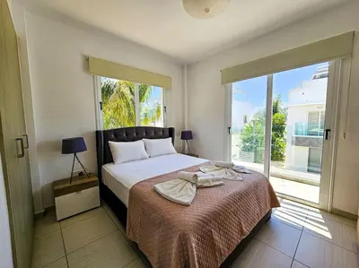 a bedroom with a bed and a large window at Nissi beach villa Holiday in Ayia Napa