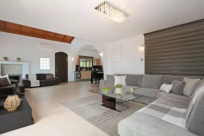 a living room with a couch and a table at Villa Lara - 3bed Bangalow with Large Pool in Ayia Napa