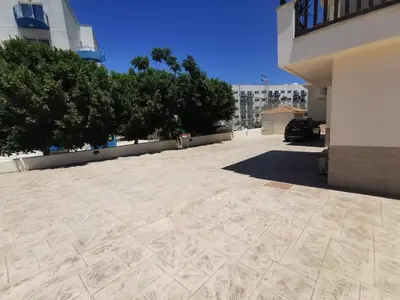 an empty parking lot in front of a building at Sunny coast apartment by the sea in Protaras