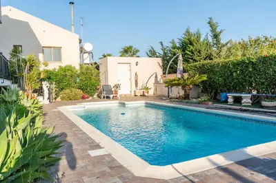 a swimming pool in the backyard of a house at ROSE VILLA - 3 BED POOL in Episkopi Lemesou