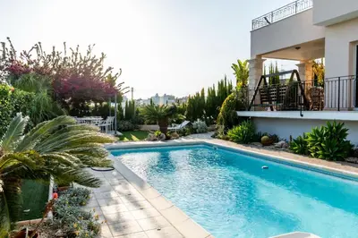 a swimming pool in front of a house at ROSE VILLA - 3 BED POOL in Episkopi Lemesou