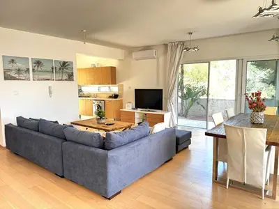 a living room with a couch and a table at Wealthystays Niceday Hill Villa in Protaras