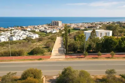 a road with a view of a city and the ocean at Wealthystays Niceday Hill Villa in Protaras