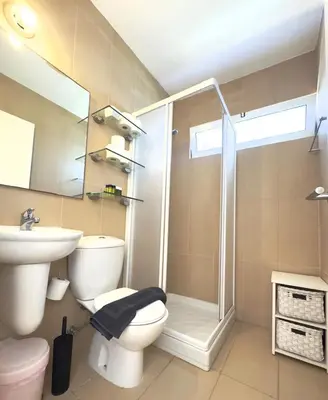 a bathroom with a shower and a toilet and a sink at Wealthystays Niceday Hill Villa in Protaras