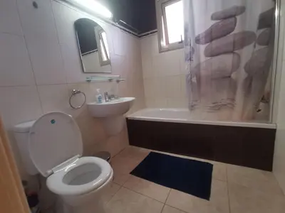 a bathroom with a toilet and a shower and a sink at Beach bliss apartment in Protaras