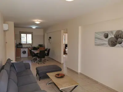 a living room with a couch and a table at Beach bliss apartment in Protaras