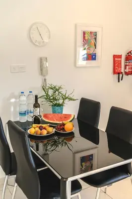 a dining room table with a bowl of fruit on it at Elegant & Central Two Bedroom Flat in Larnaka