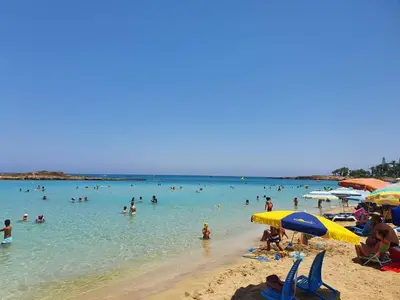 a group of people in the water at a beach at Villa Rhea in Ayia Napa