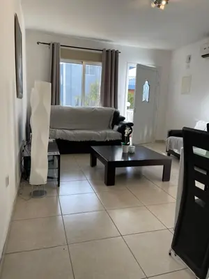 a living room with a couch and a table at Villa Rhea in Ayia Napa