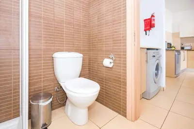 a bathroom with a toilet in a shower stall at Austin - Coralli Beachfront Apartment in Protaras