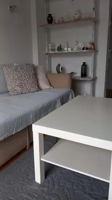 a living room with a couch and a white table at Sea view in Limassol