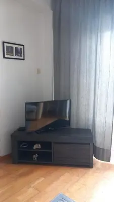 a black entertainment center with a flat screen tv at Sea view in Limassol