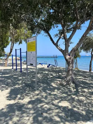 a sign on the beach next to a tree at Sea view in Limassol