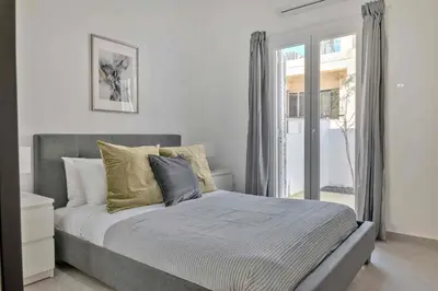 a bedroom with a large bed with a window at Phaedrus Living: Luxury Residence Faneromeni in Larnaka