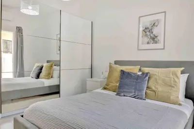 a bedroom with two beds and a mirror at Phaedrus Living: Luxury Residence Faneromeni in Larnaka