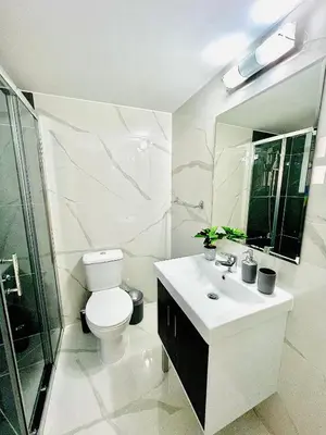 a bathroom with a toilet and a sink and a shower at Nicolas 1 in Larnaka