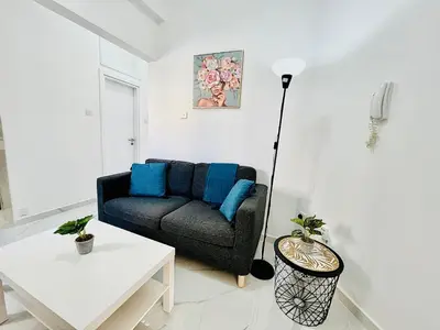 a living room with a couch and a table at Nicolas 1 in Larnaka