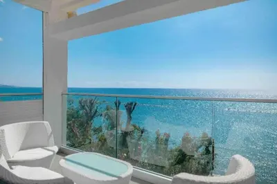 a room with a large window with a view of the ocean at Phaedrus Living: Beach Front Flat Kyma in Limassol