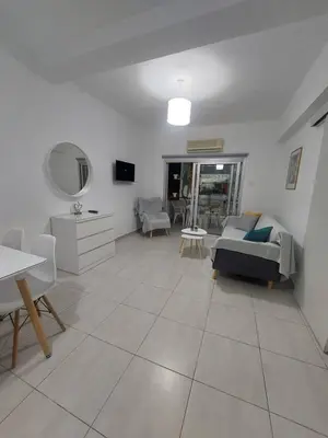 a living room with a couch and a table at One bedroom city centre in Larnaka