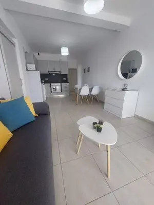 a living room with a couch and a table at One bedroom city centre in Larnaka