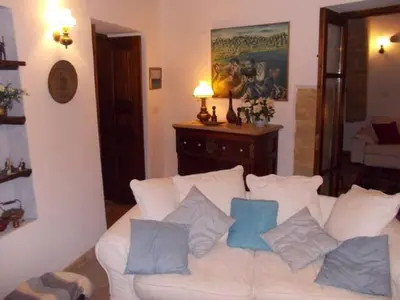 a living room with a white couch with blue pillows at Historical House in the Old City of Nicosia in Nicosia